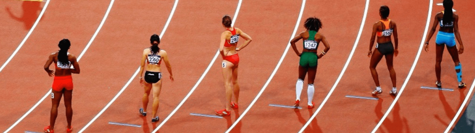Female athletes running on track